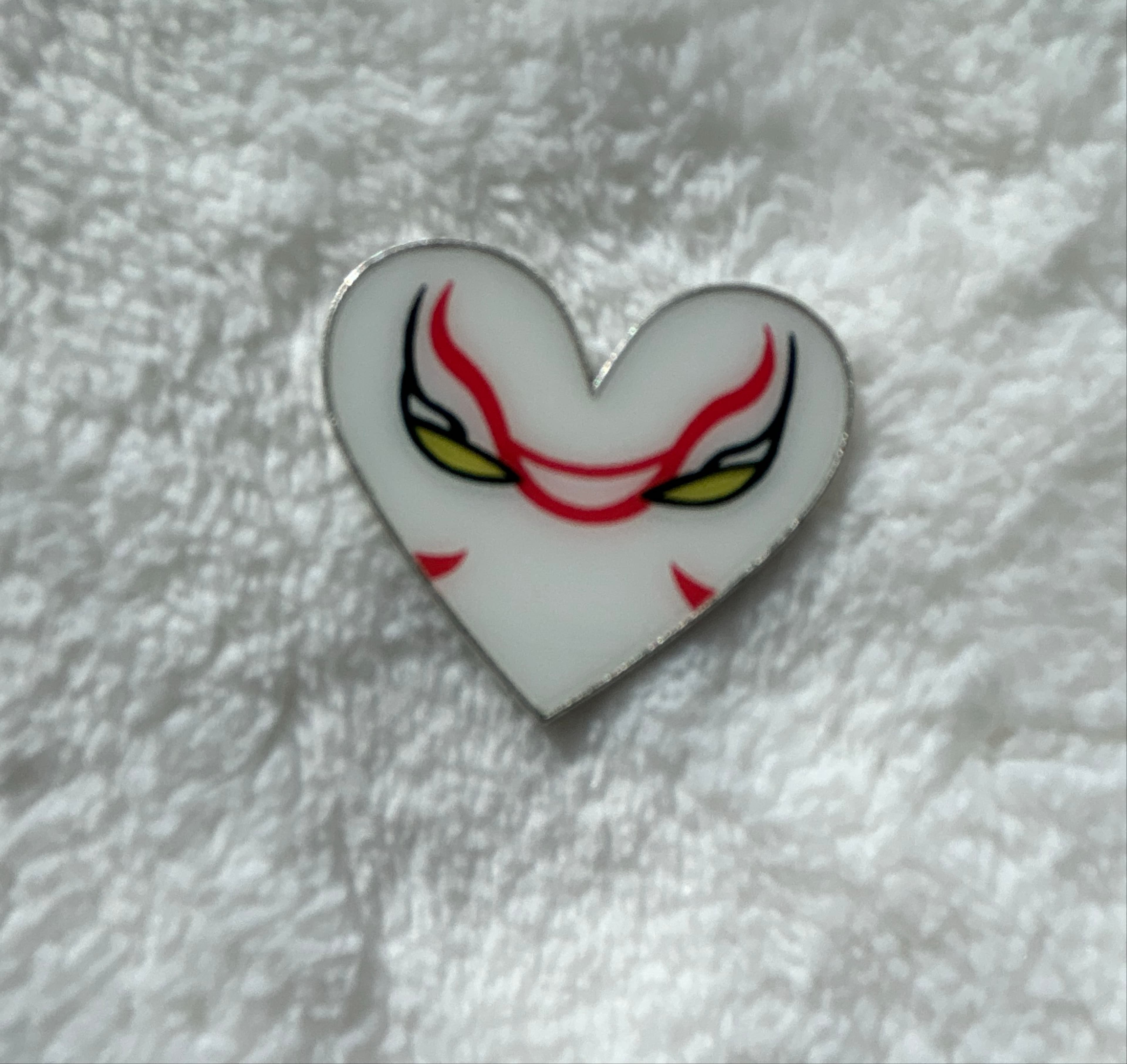 Stylized Mask Face Heart Pin - White with Red Markings and Yellow Eyes