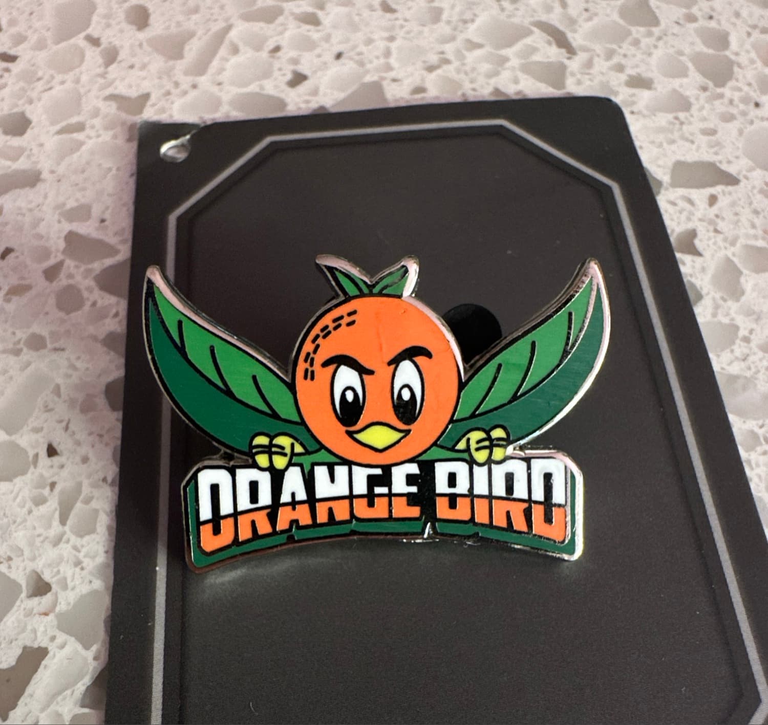 Orange Bird with Green Leaf Wings and 'ORANGE BIRD' Banner Pin