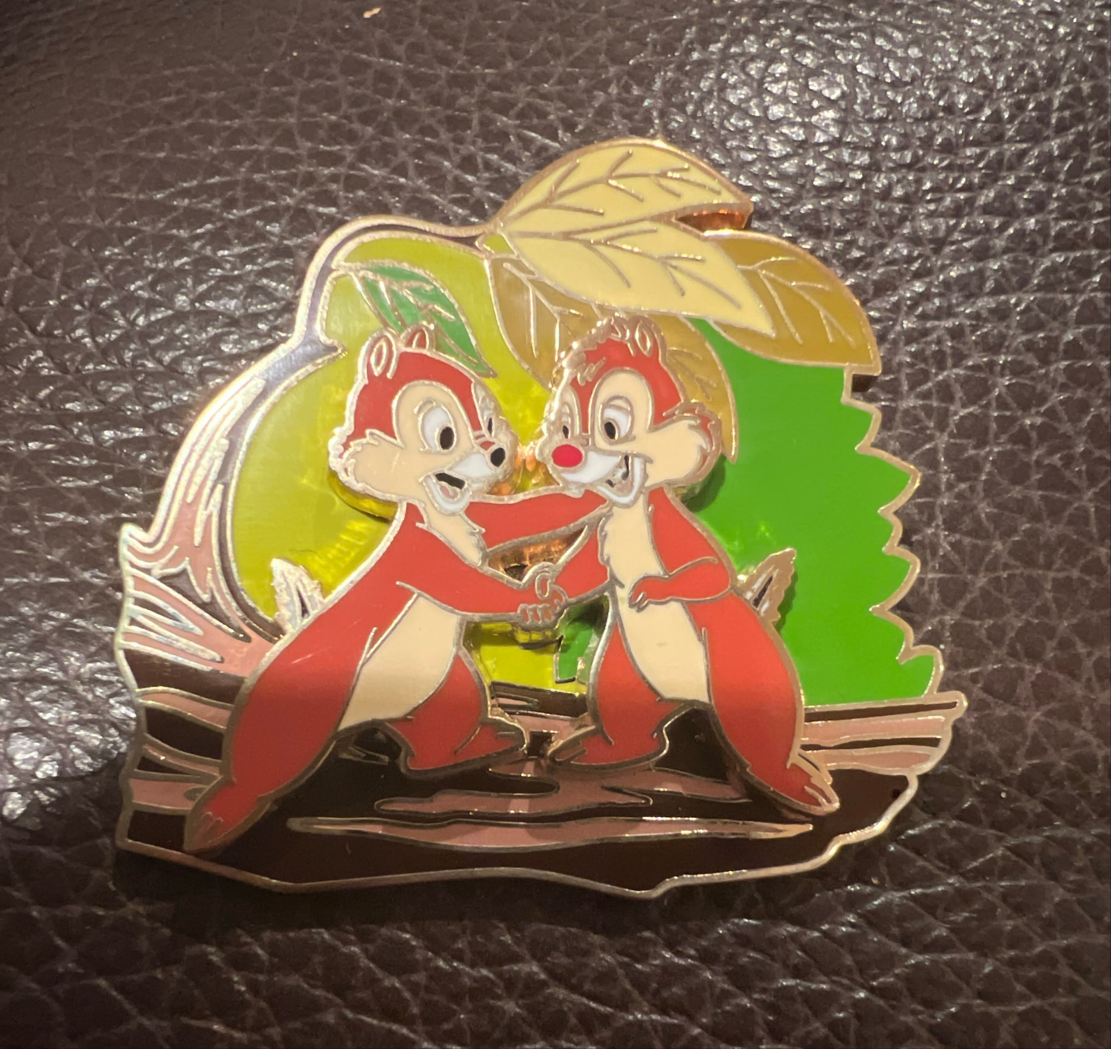Chip and Dale Shaking Hands on Log with Green Leaf Background