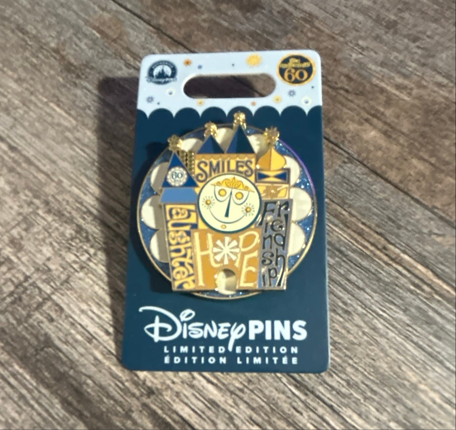 it's a small world 60th Anniversary Clock Face Pin with Smiles, Laughter, Hope, and Friendship