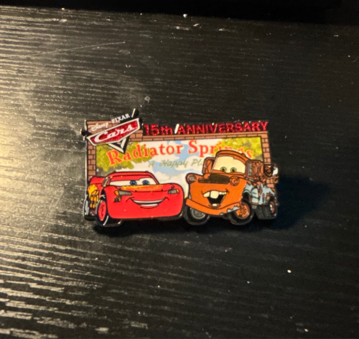 Lightning McQueen and Tow Mater in front of Radiator Springs Billboard - Cars 15th Anniversary